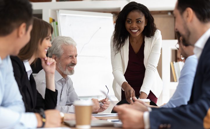 Diverse businesspeople gathered together for negotiations lead by african businesswoman